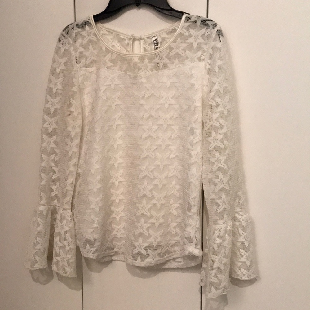 Fancy white blouse with Flowey sleeves and stars.
